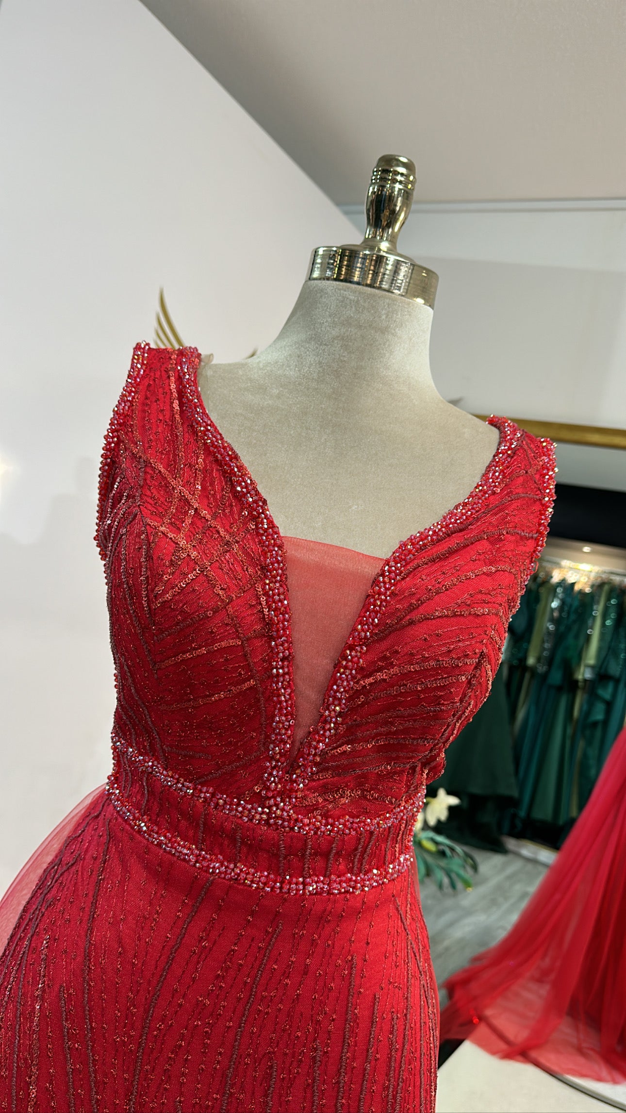Elegant red dress with train, decorated with beads