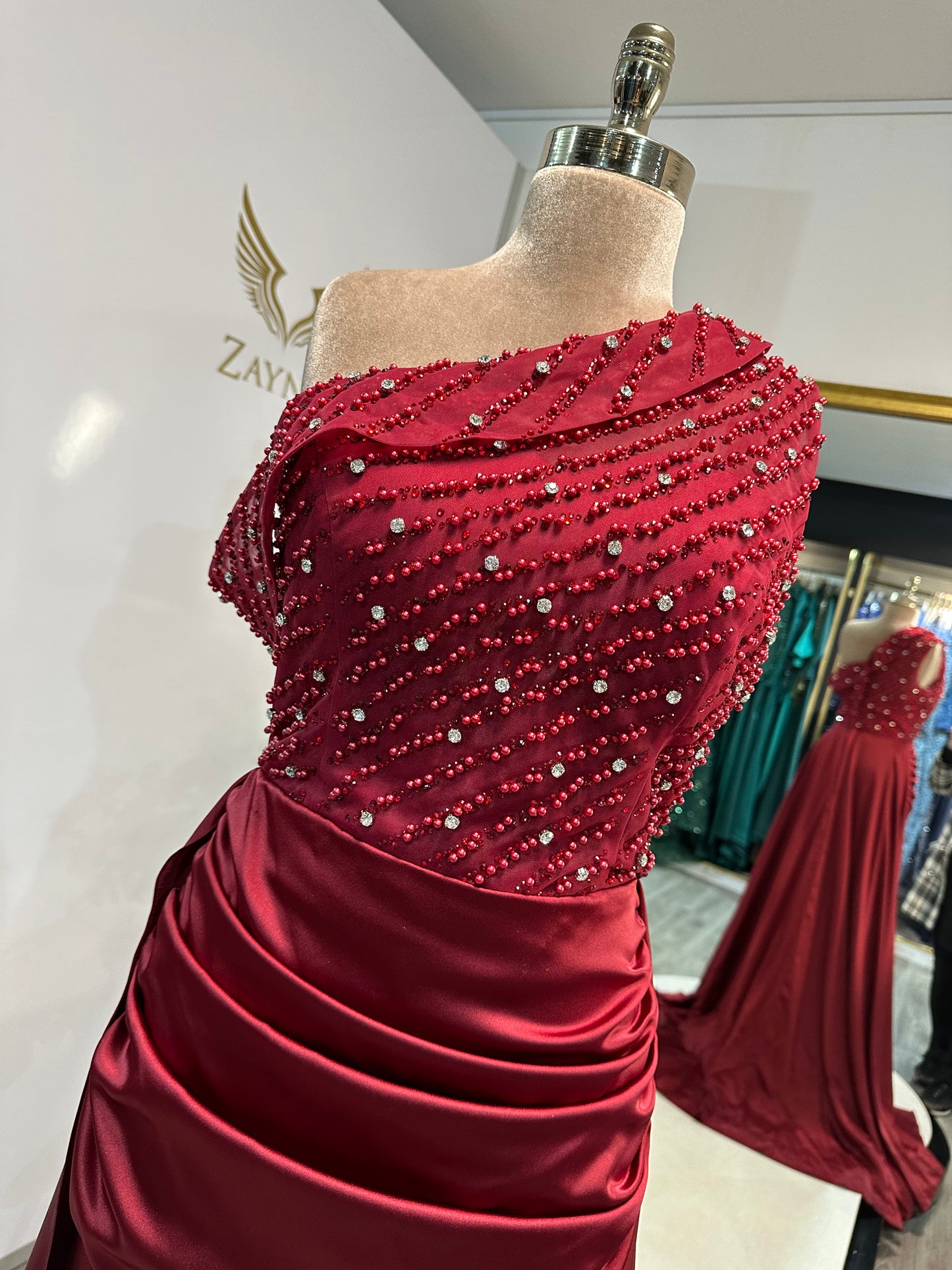 Elegant bordo dress decorated with beads, satin