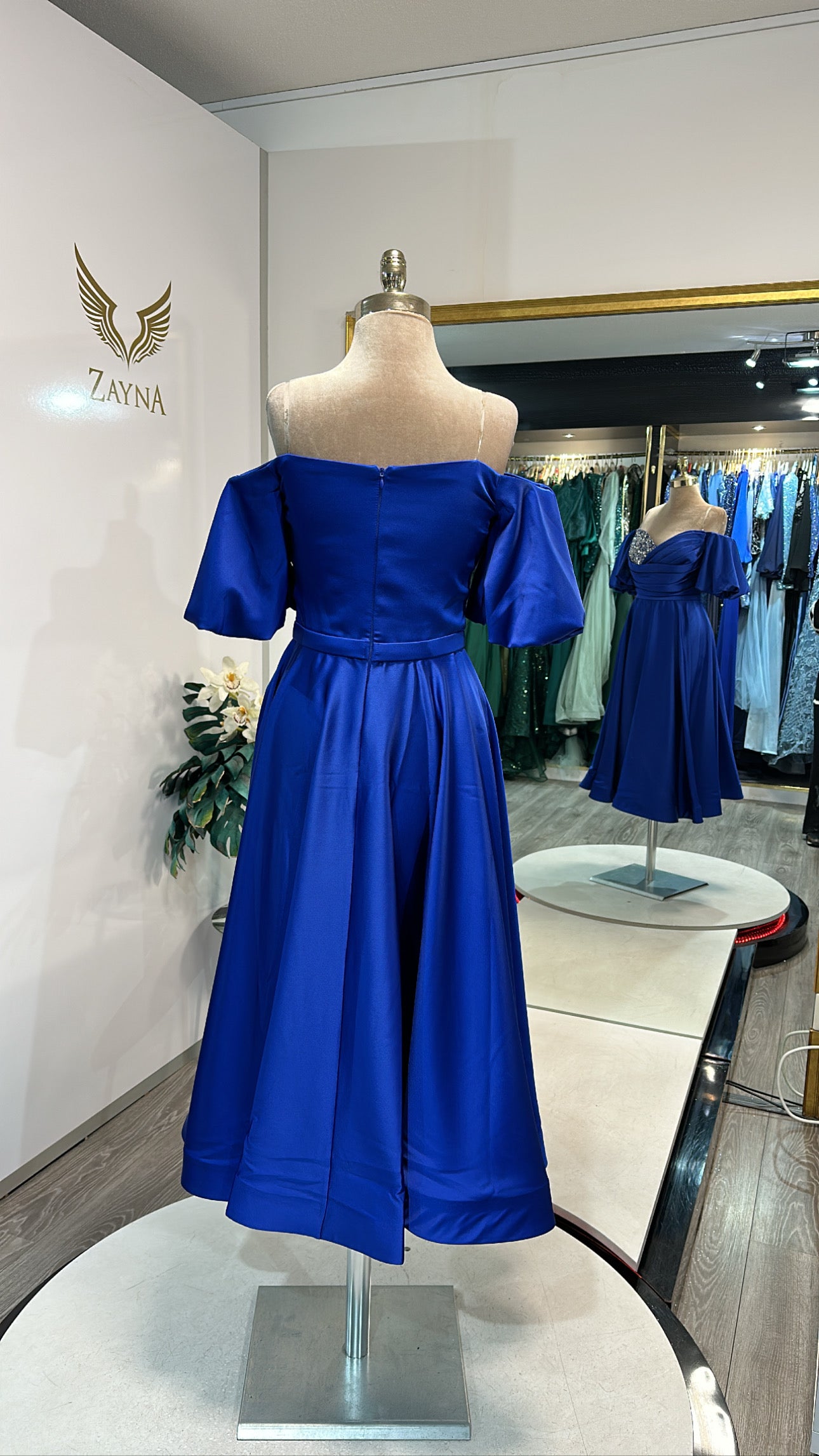 Elegant blue midi dress decorated on one side