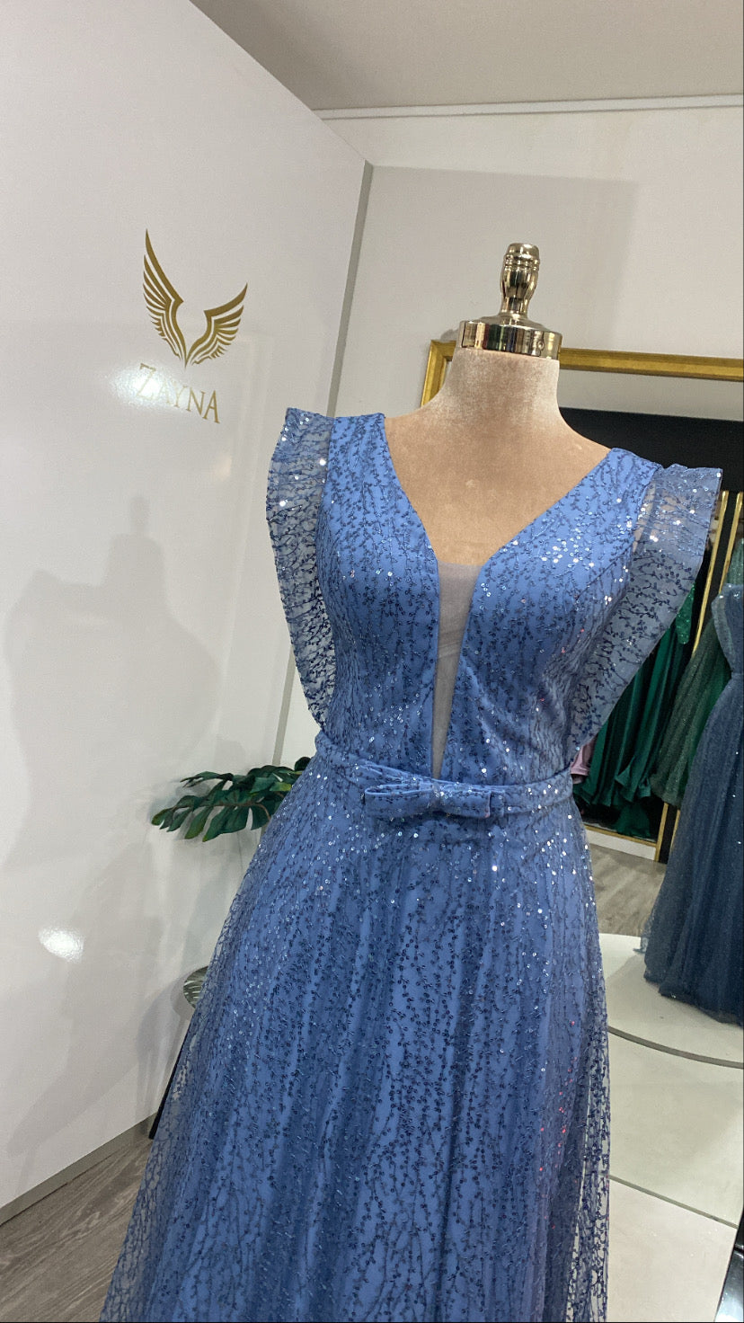 With pearls and glitter blue dress.
