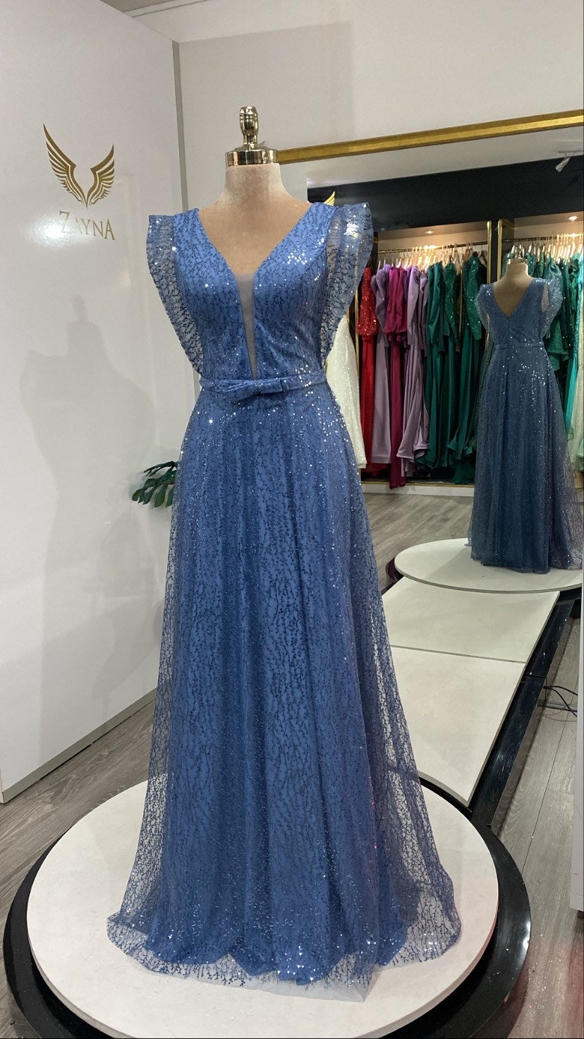 With pearls and glitter blue dress.